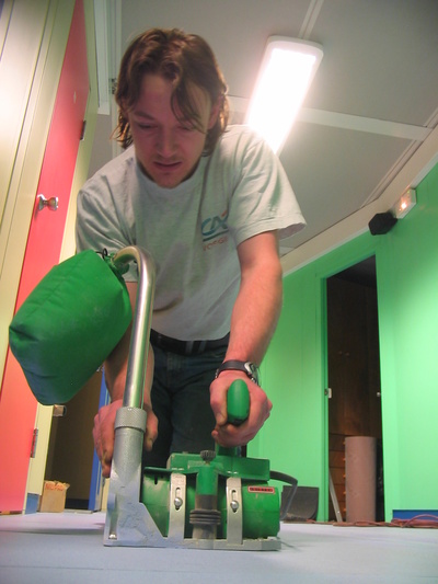 [20050808_013_Mondo.jpg]
Stef sharpening the space between the tiles, before pouring sealant along the holes. The bedroom floor is now almost done.