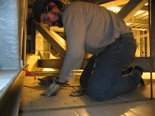 [20051007_031_CeilingHole.jpg]
Jeff cutting one of many holes through the ceiling of each room in the station, to add air conditioning pipes.