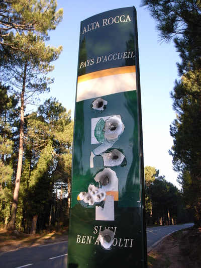 [20061109-093834-ShotSign.jpg]
Typical of the corsican roads: a roadsign riddled with bullet holes. The other local custom regarding signs is to scratch the names of the cities when spelled in french instead of corsican, so expect some discrepancies with your road map...