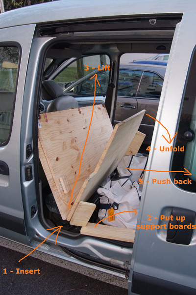 [20071125_152851_Kangoo.jpg]
The system inserted into the car and ready for deployment. If operating in two people, get one inside between the seats and one inside from the back. Lower the back board and push it below the plastic speaker supports. Install all the support boards after that (there are 5 of them at this point).