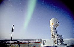 AuroraAboveAntenna2 - Aurora above a satellite antenna.